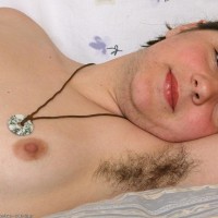 Furry Euro amateur showing off unshaven armpits and all-natural coochie on bed
