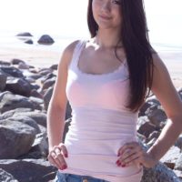 Little dark haired amateur Olivia showing off puffy teener boobies outdoors on rocky beach