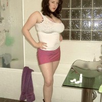 Brown-haired MILF Angela Milky modelling non naked in micro-skirt and in washroom and kitchen