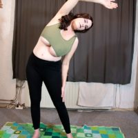 Enticing red-haired solo female Cleo extracts her enormous boobs during a yoga routine