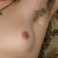 European amateur Gypsy shows off her pierced nipples and her fur covered pits and bush