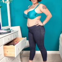 Plump black-haired solo female Elaina Gregory unveils her fun bags in jeans and stilettos