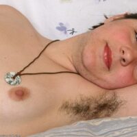 First timer displays her fur covered underarms and natural vagina on a bed