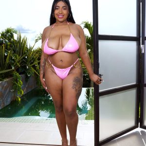 Thick Latina girl Thayana oils up her huge tits after taking off her bikini top