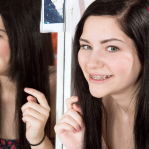 Barely legal dark haired Karly Baker showcases her braces former to getting downright naked